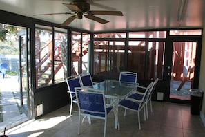 Screened Portch with sliding glass windows.
