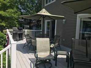 Large deck with tables and chairs.