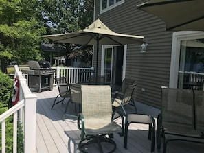 Large deck with tables and chairs.