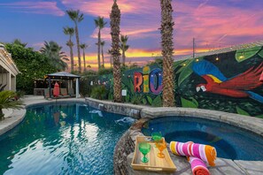 The resort style backyard highlights a large pool, spa, lounge chairs, two fire pits and much more!