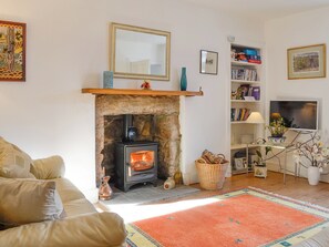 Warm and welcoming living room with open fireplace | Craigclunie, Ballater