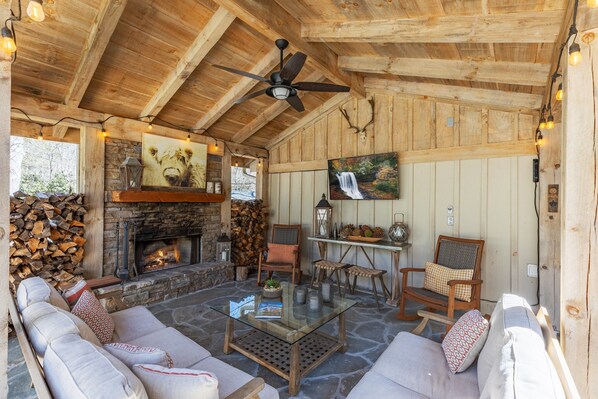 Enjoy a wood burning fire on the private covered back porch with TV