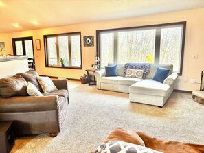 Open concept 1st floor Living/Dining/Kitchen area with a view of the woods