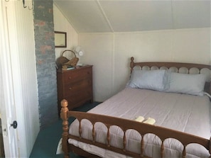 bedroom with queen bed and waterview