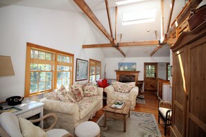 Living room has skylights and vaulted ceiling