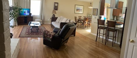 Open concept, Vaulted living room with floor to ceiling windows red rock views.