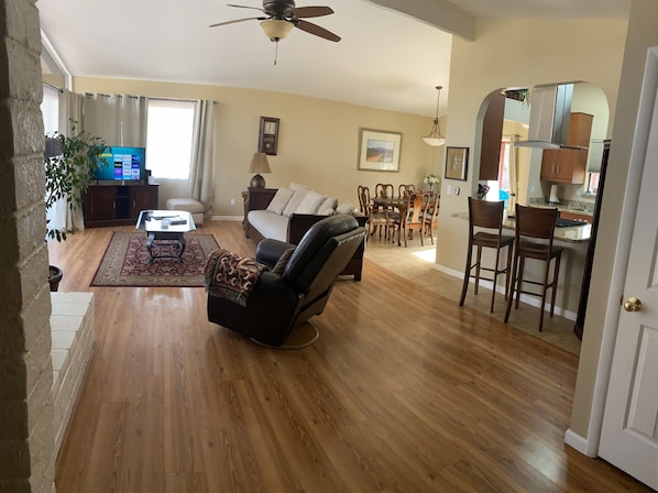 Open concept, Vaulted living room with floor to ceiling windows red rock views.