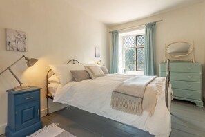 Willow Cottage, North Creake: Dual aspect master bedroom with traditional lattice windows