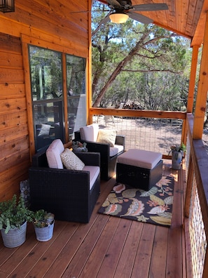 The covered porch has a view of the waterfall, birds, deer and wild turkey