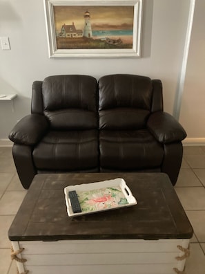 Living area with this cozy, leather, power recliner.  Great for naps! 