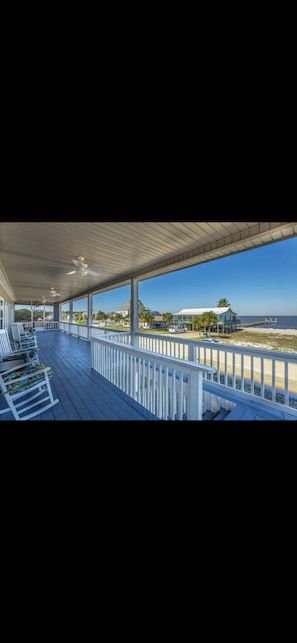Relax on the 16X72 front porch while watching dolphins swim in the bay