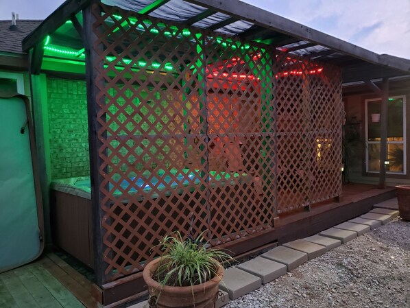 Hot Tub area w overhead net and lattice side wall for added privacy 