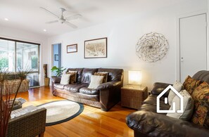 Living room with comfortable couches, smart TV and split system heating/cooling