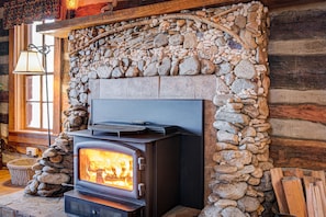 Wood burning stove with custom river rock surround.