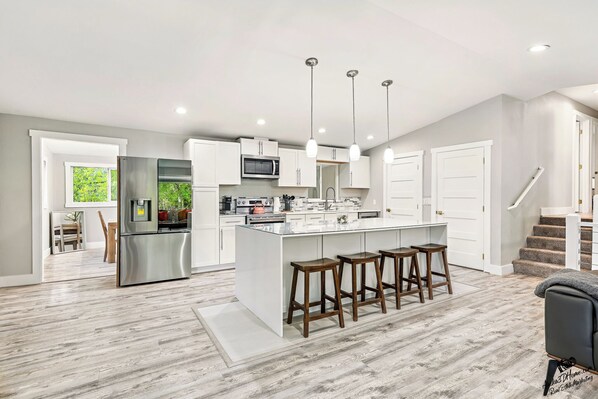 Modern kitchen with large island seating, stainless steel appliances
