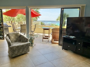 Open concept dining room/living room with amazing beach/pool view across deck 