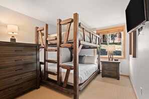 The second bedroom has a unique double bunk bed, offering a great sleeping space for your group!