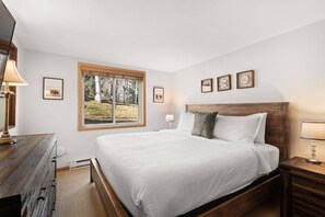 The master bedroom features a comfortable king bed, flat screen TV and en-suite bath.