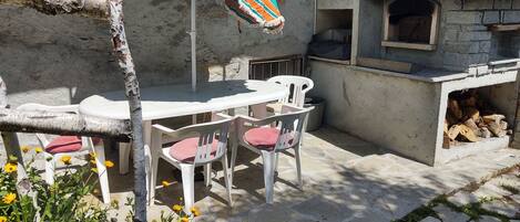 Plant, Table, Building, Shade, House, Flower, Outdoor Table, Chair, Outdoor Furniture, Road Surface