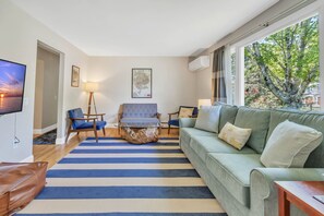 Living room with 50" UHD Smart TV, and separate seating area.