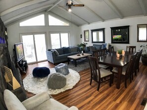 Great room- vaulted ceilings, sliding doors to wrap around deck. Dining for 8. 