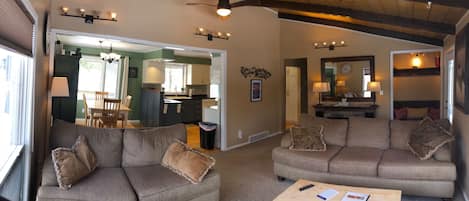 Livingroom w/lofted ceilings, electric fireplace and comfortable couches.