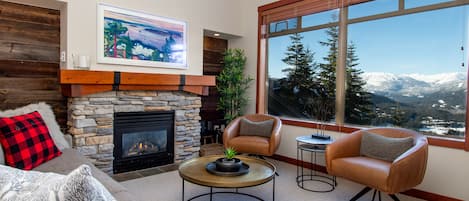 Cosy rustic-modern living room with gas fireplace and 55"  The Frame TV above.