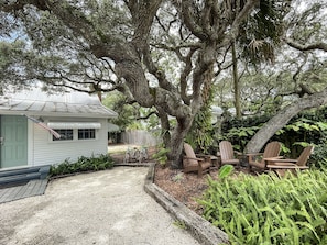 Enjoy the ocean breeze while sitting outside under the large scrub oak tree