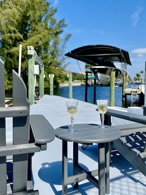 Relaxen Sie mit einem Glas Wein im Sitzbereich am Wasser.