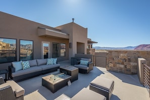 Upstairs Patio Seating Area - Stay warm next to the fire-pit and relax while watching the sunset over the red mountains.