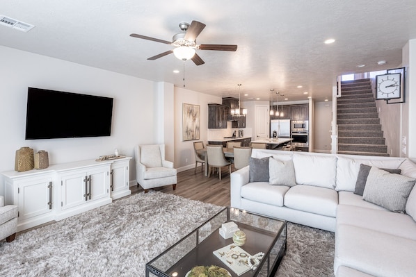 Family Room View Into Kitchen - The Living Room is located adjacent to the dining room and is the perfect place to relax and watch your favorite movie or TV program.