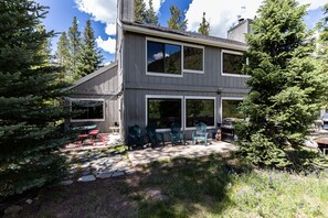 The patio features two seating areas and a gas grill.