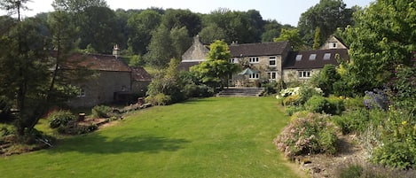 The riverside lawn can be set up with sun loungers and garden games. 