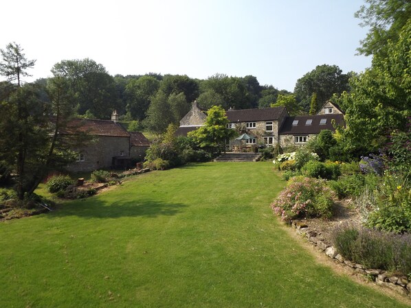 The riverside lawn can be set up with sun loungers and garden games. 