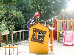 Tree, Chute, Playground Slide, Plant, Yellow, Outdoor Recreation, Playground, Leisure, Asphalt, Stool