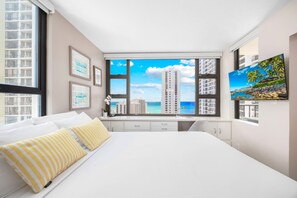 Bedroom with a queen-size bed, 32" Smart TV, and beautiful ocean views
