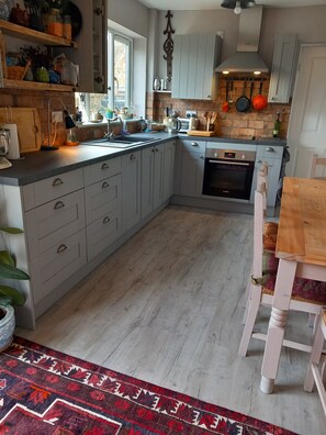 kitchen with dishwasher, microwave and everything you might need for your stay 
