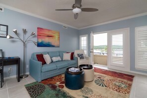 Living area offers bright colors, lots of natural light and beautiful views from balcony