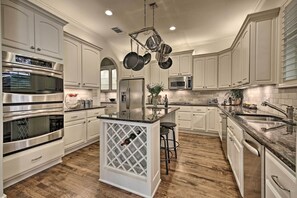 This kitchen is home to stainless steel appliances & granite counter tops.