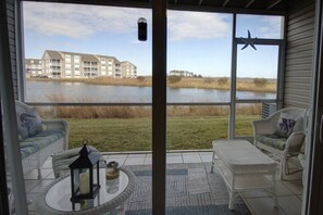 Relax on the screened-in porch with a drink.