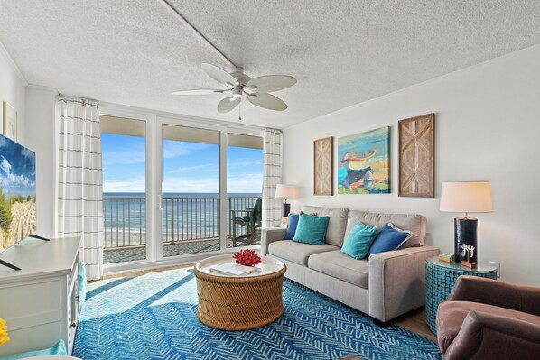 Living room with queen sleeper sofa and Gulf-facing balcony.