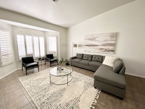 The main living area features a comfy sectional and flat screen TV