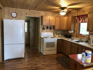 KITCHEN AREA—fridge, stove, microwave, toaster, and coffeemaker 
