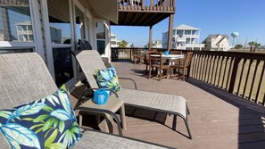 Main deck has plenty of seating and beach views with gated stairs 