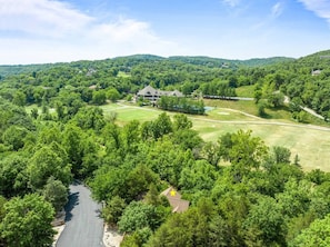 Our cabin is surrounded by trees with Roark's Creek running by and backs up to Ledgestone Golf Course. One of the best locations in Stonebridge!