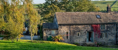 Front view of the property with hills behind