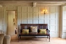 This settle, beamed ceiling and panelled walls add a sense of age and period.