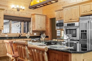 Enjoy dinner in this chefs kitchen including a double oven and island cooktop!