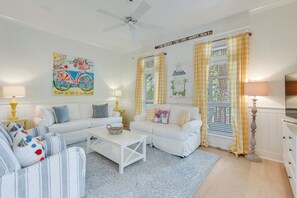 - Cozy corner of the living room filled with natural light, comfy textures, and relaxed style - Bright gingham curtains, a soft rug, and cheerful wall art create a lived in vibe - Great spot for reading, sipping coffee, or chatting with loved ones