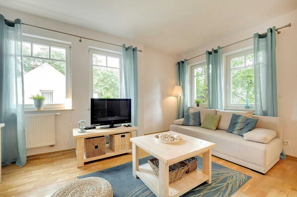 Living room with a comfortable sofa and TV. 